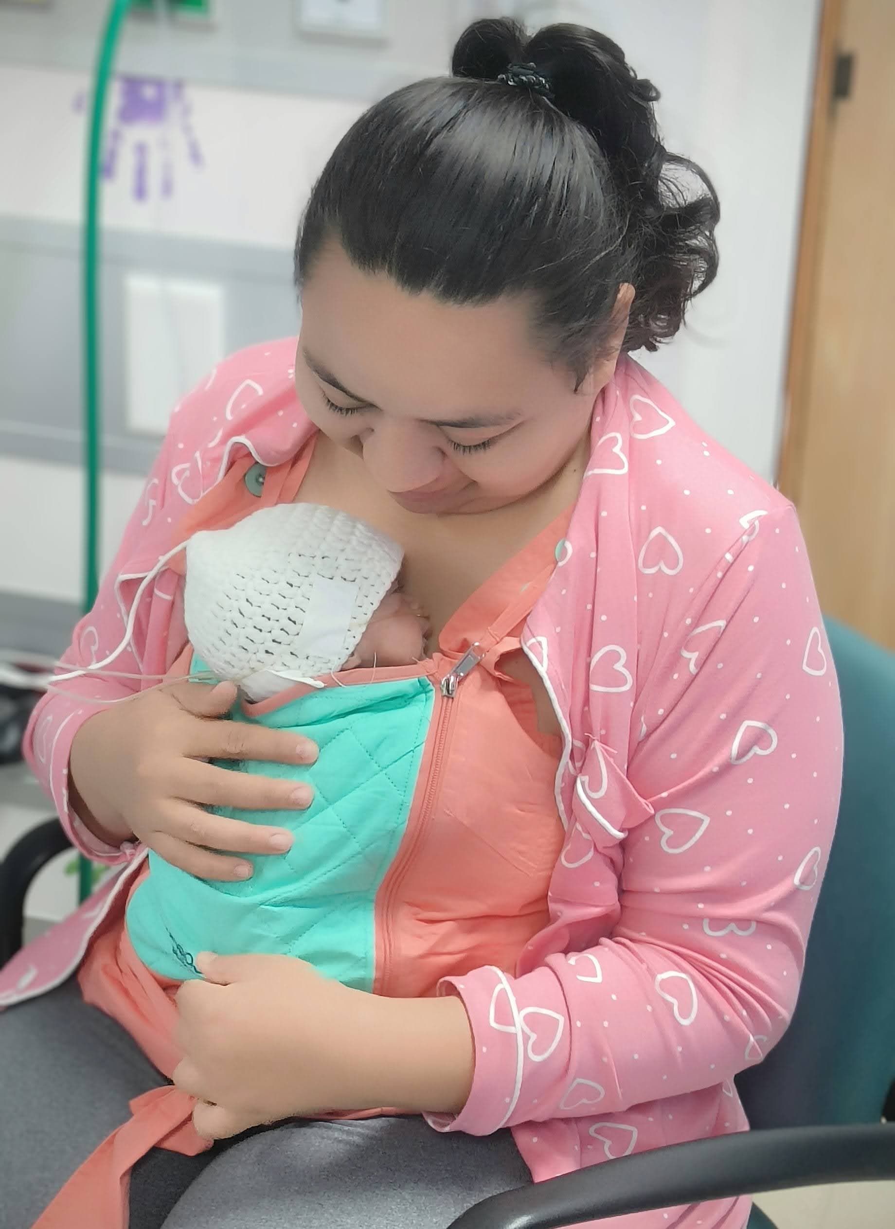 Mother in Belize using BEMPU KangaSling for kangaroo care