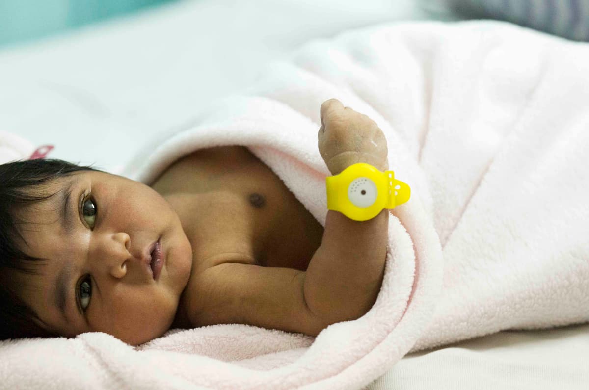 Newborn baby wearing TempWatch hypothermia alert bracelet